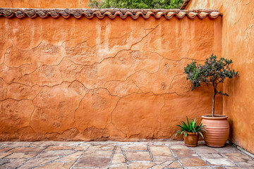 The masonry of the ancient courtyard wall has been rendered in a terracotta hue.