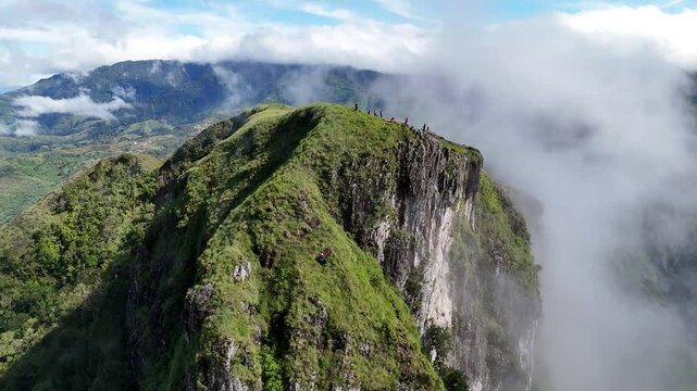 Hikers standing on the summit of Cerro Pe&ntilde;a Blanca surrounded by clouds and panoramic views in Ng&auml;be-Bugl&eacute;, Panama