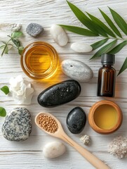 Fototapeta premium beauty treatment items for spa procedures on white wooden table. massage stones, essential oils and sea sal