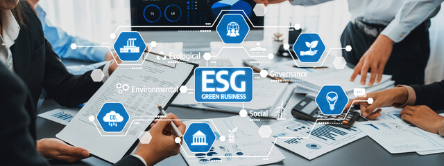A dynamic team collaborates on green business strategies in a modern office, focusing on ESG principles to drive sustainable growth and effective governance in their initiatives. Amity