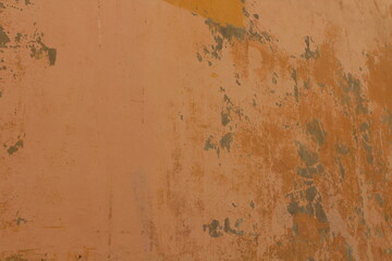 Orange dirty wall textured background. Rough rusty and damaged orange wall texture