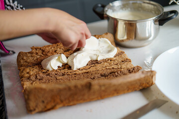 Baking a dessert with whipped cream in a cozy kitchen setting in the late afternoon