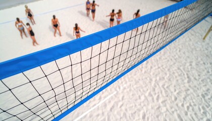 Group of women playing beach volleyball on a sunny day with a net in focus and sand background