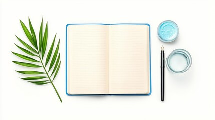 An open notebook with a pen, paint, and a palm leaf adds a creative touch to your workspace and inspires imagination.