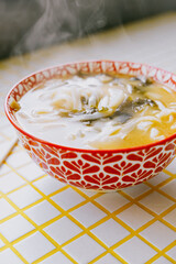 plate of noodles and chopsticks. vegetable ramen in a bright blue plate. Asian dishes, spicy miso soup with meat. delicious homemade food, lunch. instant noodles, fast food.