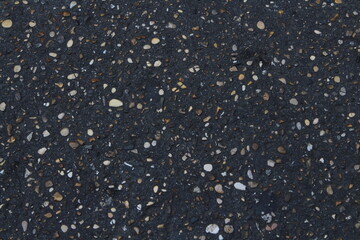 Grainy asphalt textured abstract background. Pavement asphalt with stones and rocks background