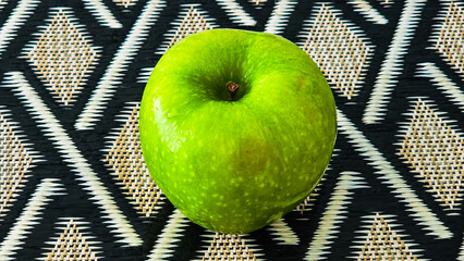 Green Apple On Woven Mat