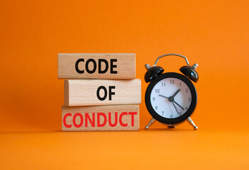 Code of conduct symbol. Wooden blocks with words Code of conduct with alarm clock. Beautiful orange...