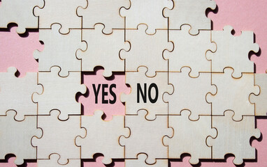 Yes or No symbol. Concept word Yes or No on wooden puzzle. Beautiful pink background. Business and...