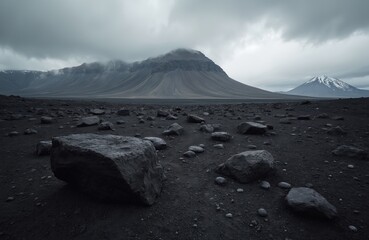 Volcanic landscape with black lava rocks, ash, mountain range on Iceland. Rocky terrain under cloudy sky, nature scenery, travel destination, dramatic environment, adventure, epic.
