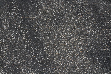 Grainy asphalt textured abstract background. Pavement asphalt with stones and rocks background
