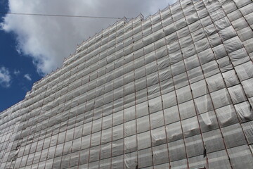 New house at final stage of construction. Finishing works of facade are in progress. Building is in...