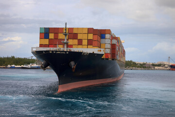 Front view of a large container cargo ship sailing over the ocean as a banner for shipping and industry