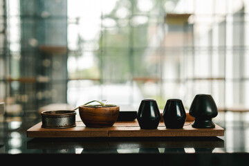 Matcha making equipment placed on a table in a coffee shop. Copy space.