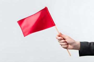 A woman's hand holds a red warning flag against a white background.