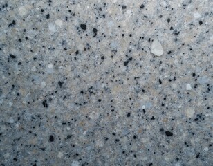 Close-up gray granite stone texture. Smooth, grainy surface. Spotted pattern, dark black dots, small white spots. Mineral rock material, natural background for interior design, architecture,