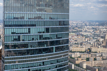 Fototapeta premium Modern Architecture of a High-Rise Building in Moscow Showcasing City Views Under Clear Skies