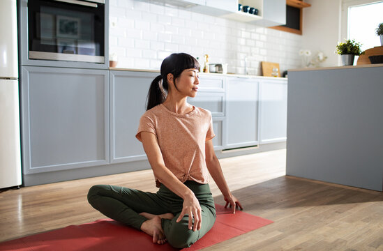 Woman practicing yoga at home