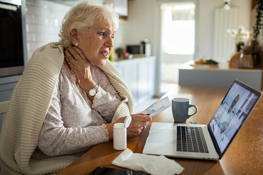 Senior woman in video call with doctor for advice at home
