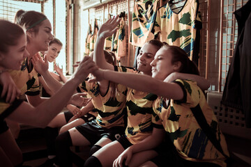 Girls soccer team getting ready in locker room before game