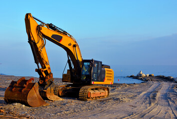 crawler excavator on the beach of cogoleto genoa italy