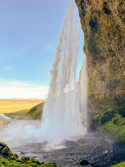 Seljalandsfoss Waterfall vertical from behind