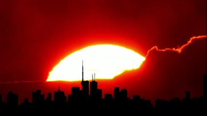 City skyline silhouette hot cinematic sun set, downtown cityscape with large sun disk sunset light. Artistic effects. Epic hot summer sky with buildings and yellow sun disk. Heat wave warning. - Powered by Adobe