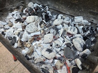 Grilled charcoal ashes in barbecue pit for summer outdoor cooking adventures