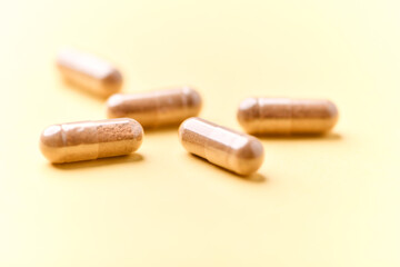 Carnitine capsules. Concept for a healthy dietary supplementation. Bright paper background. Soft focus. Close up.	
