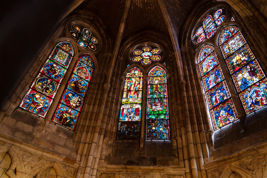 Colorful stained glass windows depicting biblical scenes, illuminating the interior of the cathedral of leon in spain