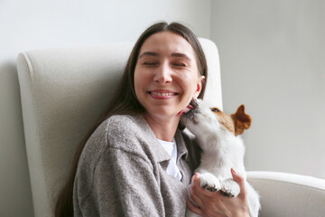 Young woman hugging her dog. Copy space, background.