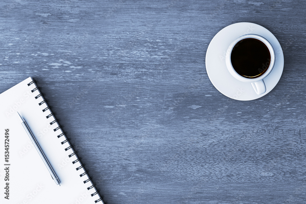 Poster blank notebook with pen and coffee cup on blue wooden desk, clean workspace background with top view
