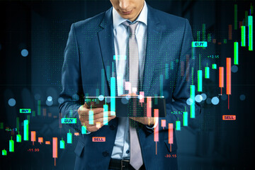Businessman analyzing forex and stock market data on tablet with digital holographic financial chart overlay in modern office background at night.