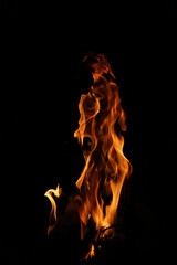 Fototapeta premium Close-up Shot of a Bonfire Flame in the Dark – Captivating Fire Texture and Burning Wood with Intense Heat, Perfect for Background