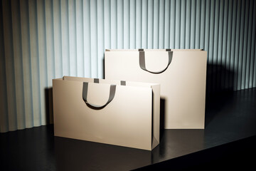 Blank luxury shopping bags mockup with soft shadows and dramatic lighting on dark floor and vertical curtain background for branding display. 3D Rendering
