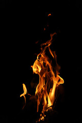 Fototapeta premium Close-up Shot of a Bonfire Flame in the Dark – Captivating Fire Texture and Burning Wood with Intense Heat, Perfect for Background