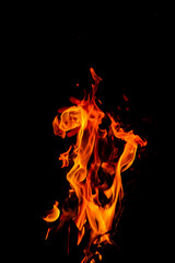 Fototapeta premium Close-up Shot of a Bonfire Flame in the Dark – Captivating Fire Texture and Burning Wood with Intense Heat, Perfect for Background