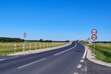 Road signs before a turn on an asphalt road