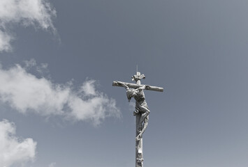 scenic and touching monochrome view of crucifix on top of a peak