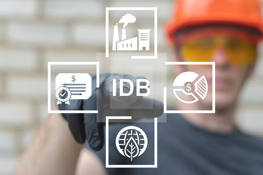 IDB - Industrial Development Bond Modern Industry Business Concept. Worker using virtual touch screen push text: IDB.