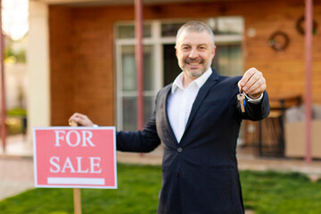 Real estate agent selling house and real estate, man giving new house key, standing near for sale...