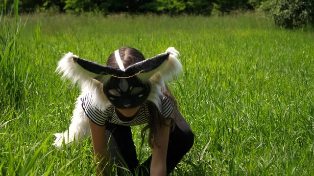 Teenage girl identifies herself as a therian, wears a mask, plays in the park, walks on all fours