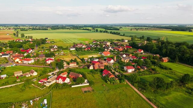 Aerial Drone Footage of a Picturesque Polish Village Nestled Among Expansive Fields