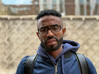 Portrait of a serious adult African American ethnicity man with a beard. A serious confident black...