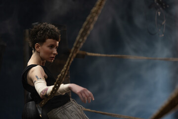 A woman in a boxing gym, portrait by the ropes, close-up. cinematic style, Respite before training, motivation