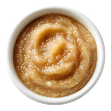 Overhead view of creamy homemade applesauce served in a white ceramic bowl with a natural light look isolated on white transparent