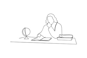 Person studying at desk with globe and books