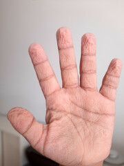 Wrinkled kids fingers and palm after long exposure to water showing natural skin texture