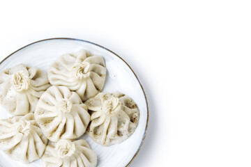 Plate with traditional georgian khinkali (dumplings) isolated on white background. Flat lay, copy space.