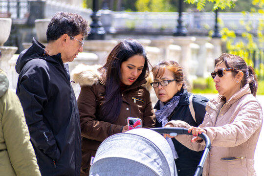 Friends sharing a moment in a vibrant park during a sunny day